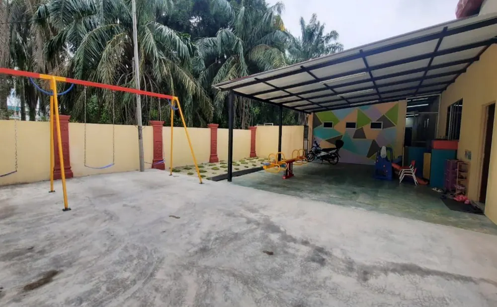 Swings and the covered play area at the school playground